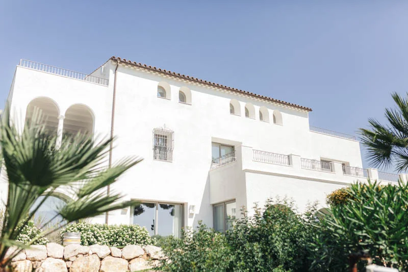 Outside view of white stone building Masia Casa Del Mar in Sitges, Barcelona