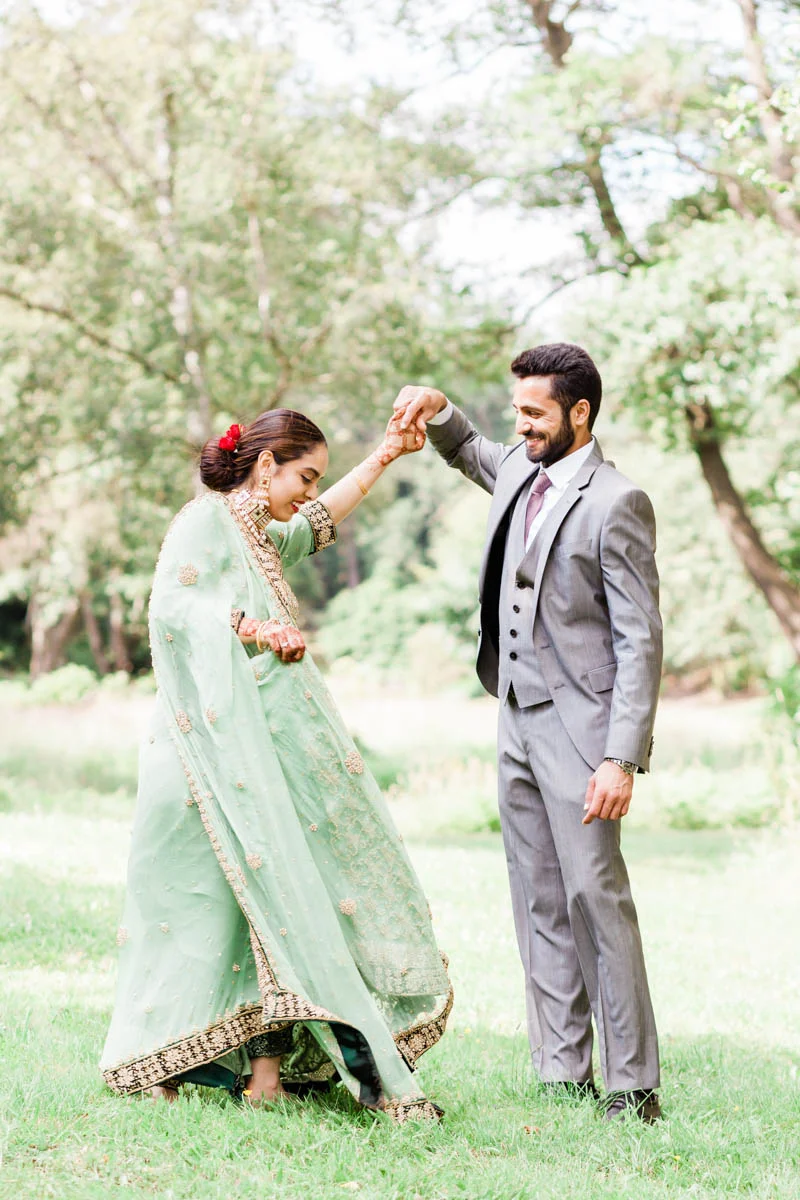 Couple holding hands dancing at Virginia Water lake in Surrey
