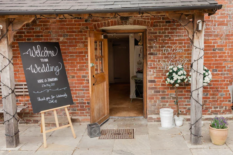 Wedding welcome sign at the entrance to the ceremony room at Sopley Mill in Dorset