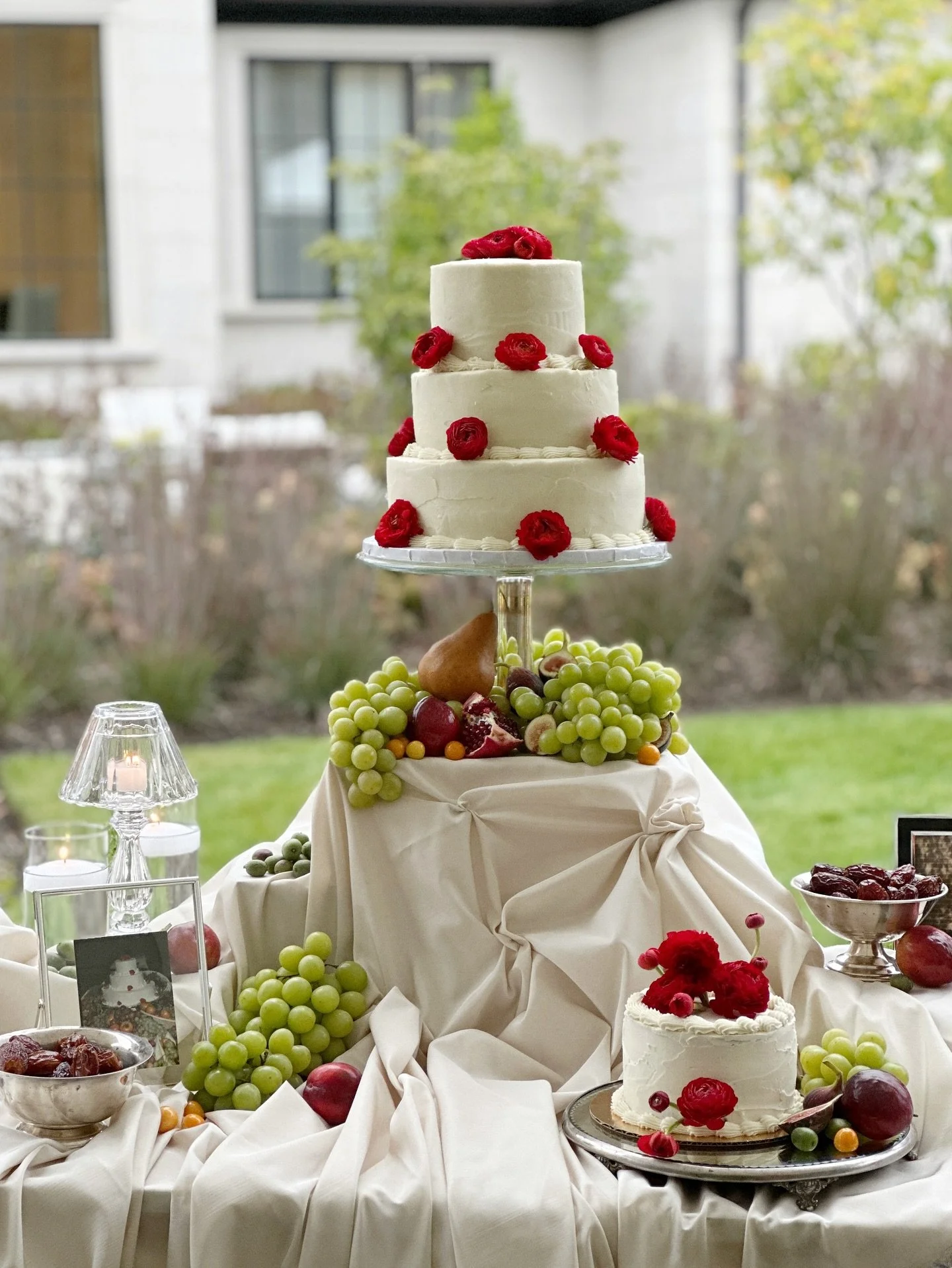 the styling was all inspired by one vintage wedding photo of the original cake. displayed with an abundance of green grapes, persimmon, plums and a variety of seasonal fruit. the linens were carefully draped and pinned to create texture and shadow. @
