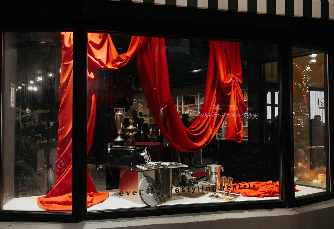 we rolled out the red carpet to honor my dearest lifelong friend in an Oscar&rsquo;s theme Celebration of Life. we dressed and draped the studio in red velvet, dramatic monochrome florals, and moody candlelight. the bar was a showstopper with a stunn