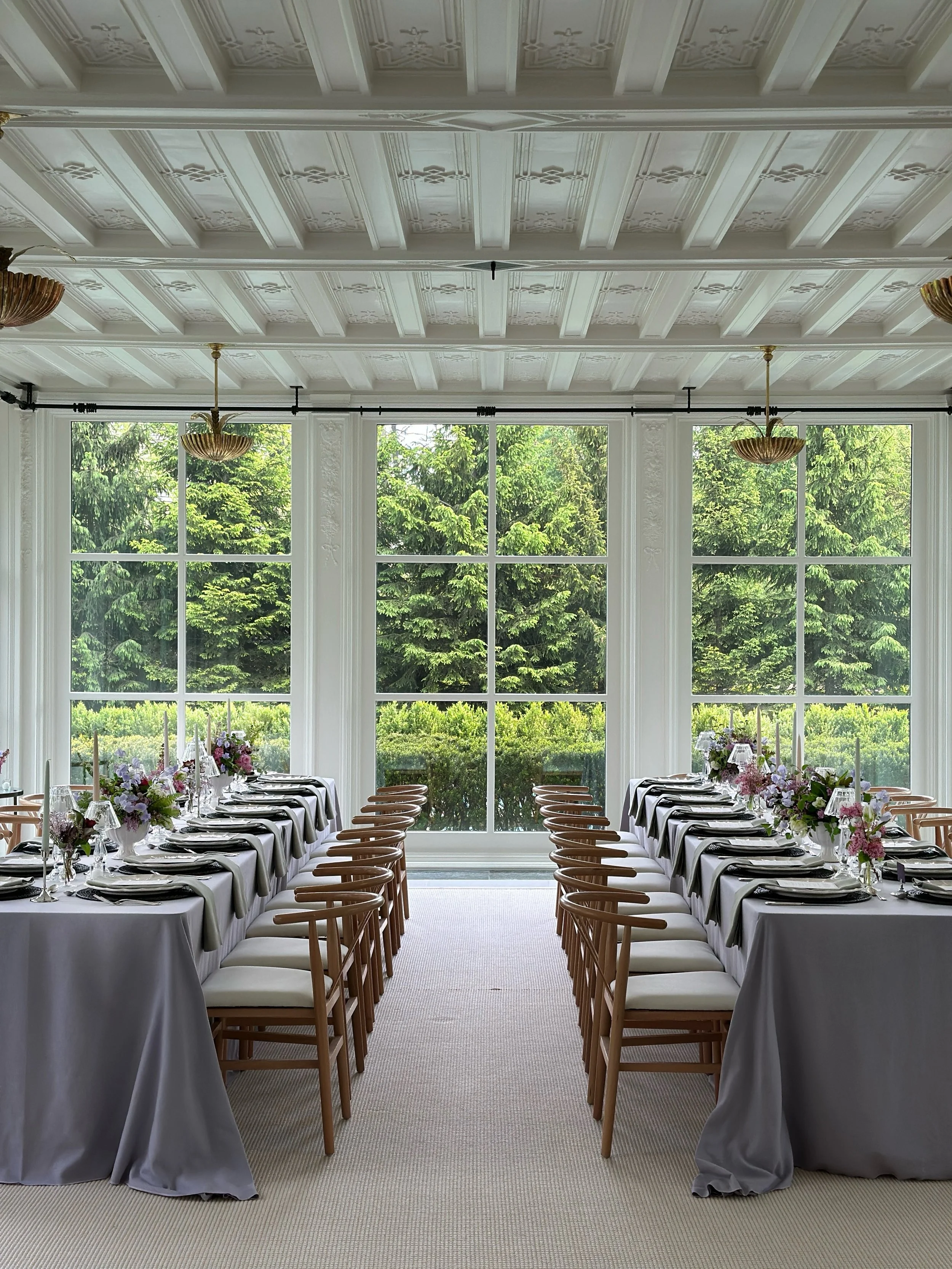 a dinner party to celebrate spring 

we set the tables in the sunroom overlooking the lake. leaning into a spring palette of lilac and soft greens, the hellebore and espresso chargers brought just enough mood for balance. gorgeous spring florals from