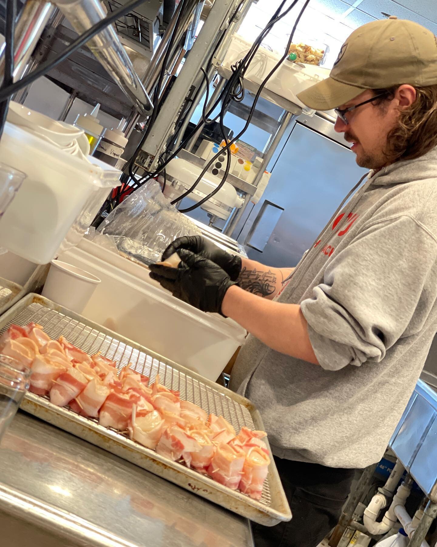 Caleb is getting our delicious bacon wrapped scallops prepped for the day! They are baked to perfection and drizzled with balsamic glaze and maple syrup!