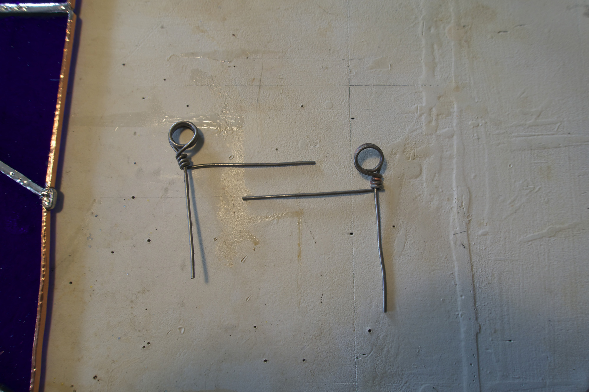 Little hanger corners are made out of some nickel plated wire and then soldered onto the top corners.
