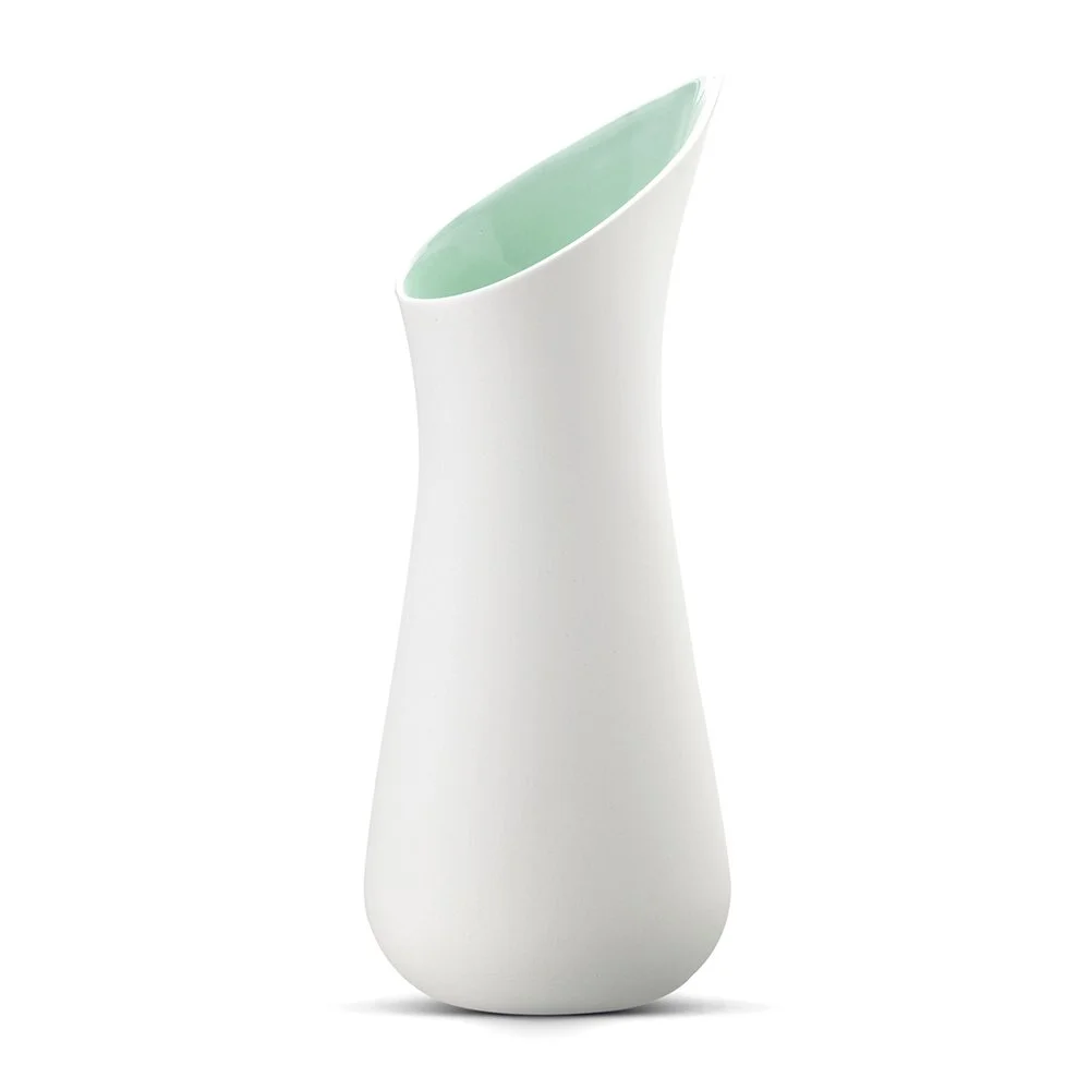 White and mint green porcelain carafe by Ditte Fischer Copenhagen, featuring a sculptural boat shaped spout and silky matte finish.