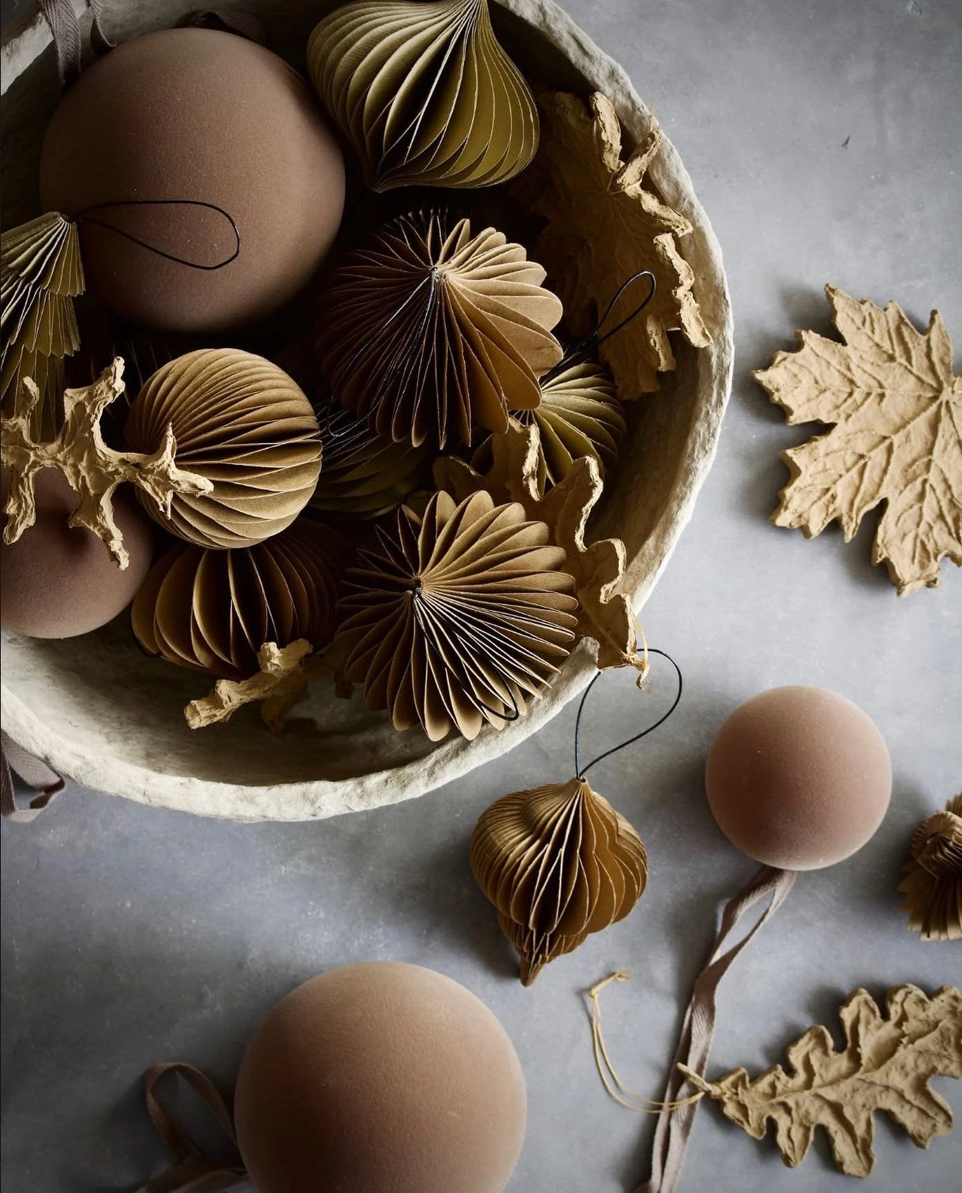 folded paper ornaments in sustainable bowl