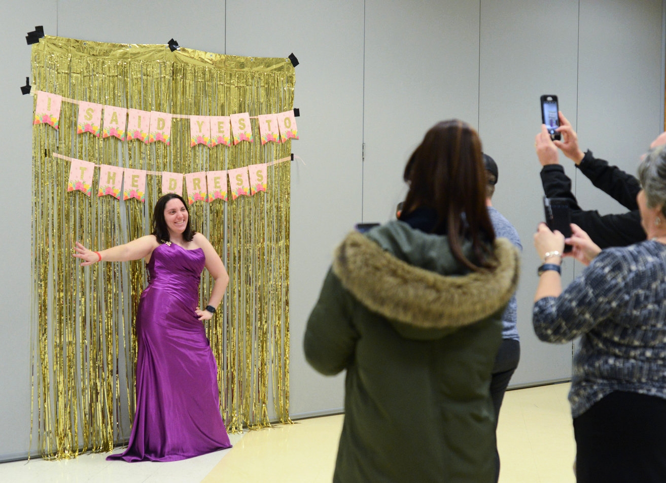 "Say Yes to the Dress" participant Jessica Cain, left, poses in front of a backdrop for a handful of photographers on Wednesday, Jan. 17, 2018 at the Activity and Recreation Center in Columbia, Mo. Cain tried on several dresses before settling on a 