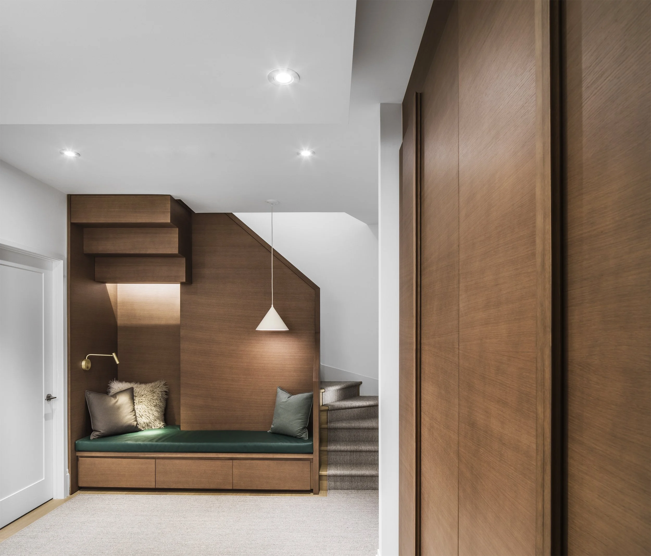 Minimalist solid oak plane central staircase design connecting three levels in a Toronto custom residential interior.