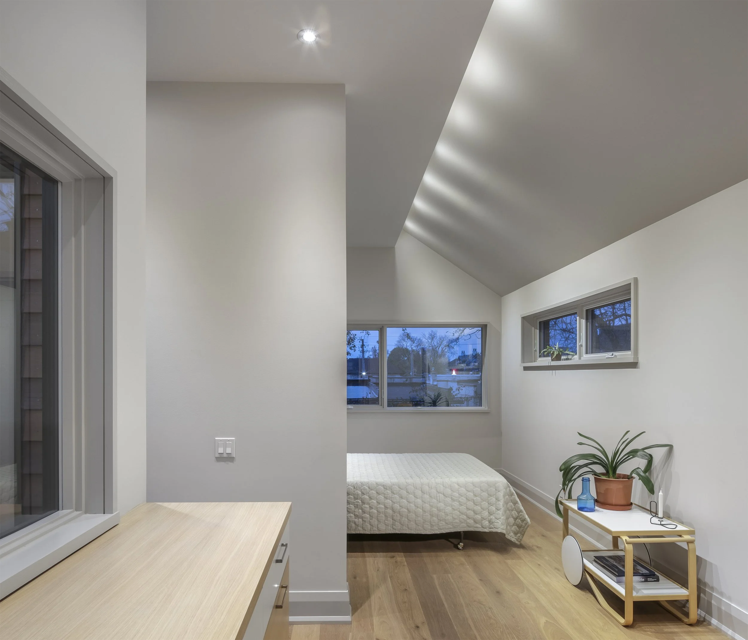 Luxury primary bedroom interior architecture featuring integrated indirect ambient cove lighting and clean minimalist walls