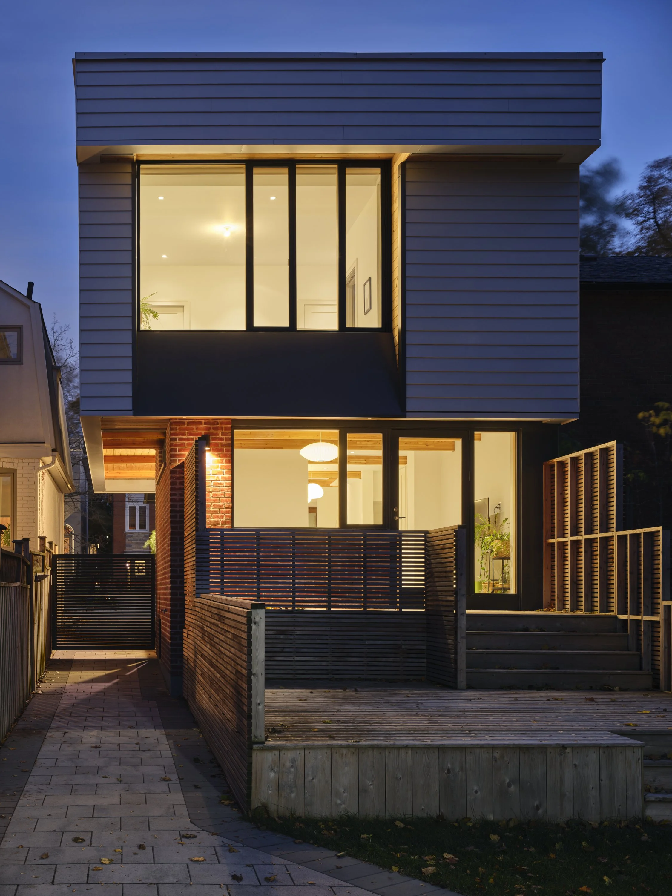 Modern home addition in Toronto Lawrence Park featuring a second story cantilever over the driveway by Wayback Architects.