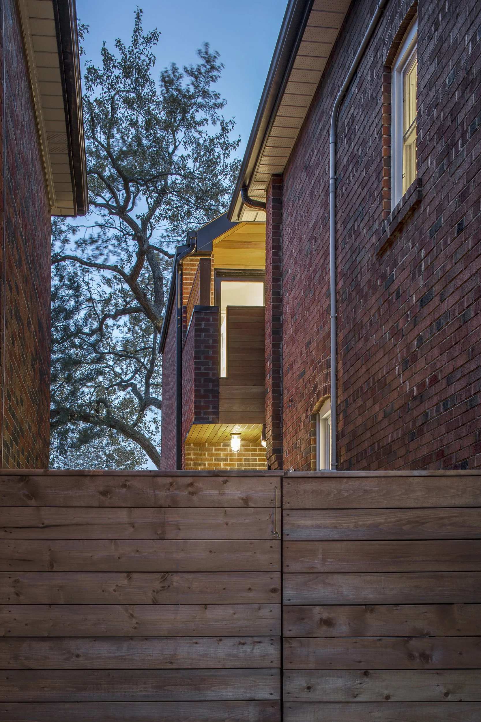 Modern residential home addition featuring heritage materials and a custom balcony leading to the primary suite in a Lawrence Park Toronto home