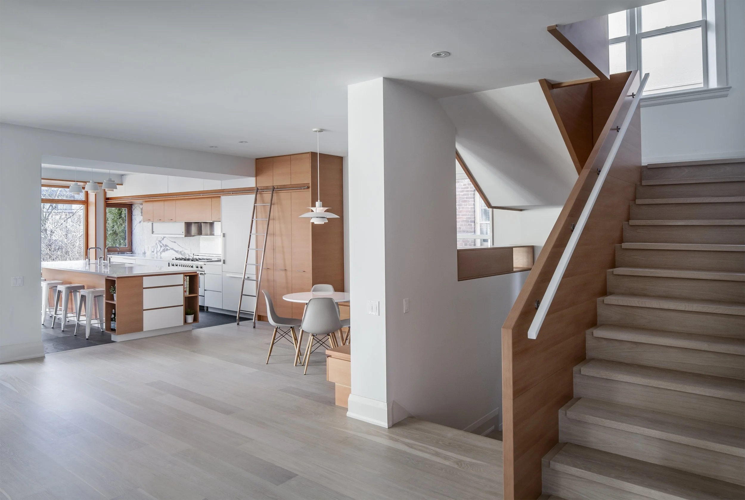 Contemporary open-plan residential layout designed to contrast a historic turn-of-the-century heritage home exterior in Toronto.