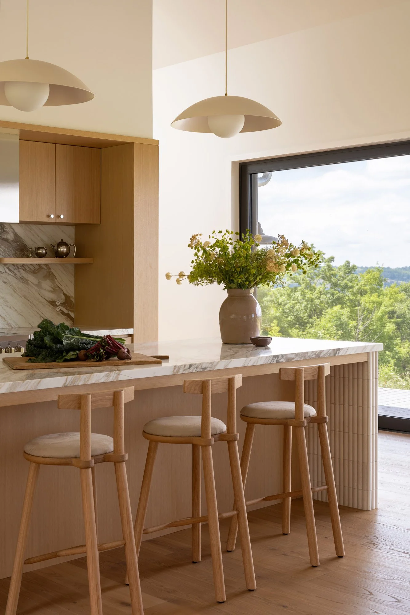 Contemporary kitchen design by Wayback Architects featuring high-end classic finishes, custom oak millwork, and premium stone surfaces.