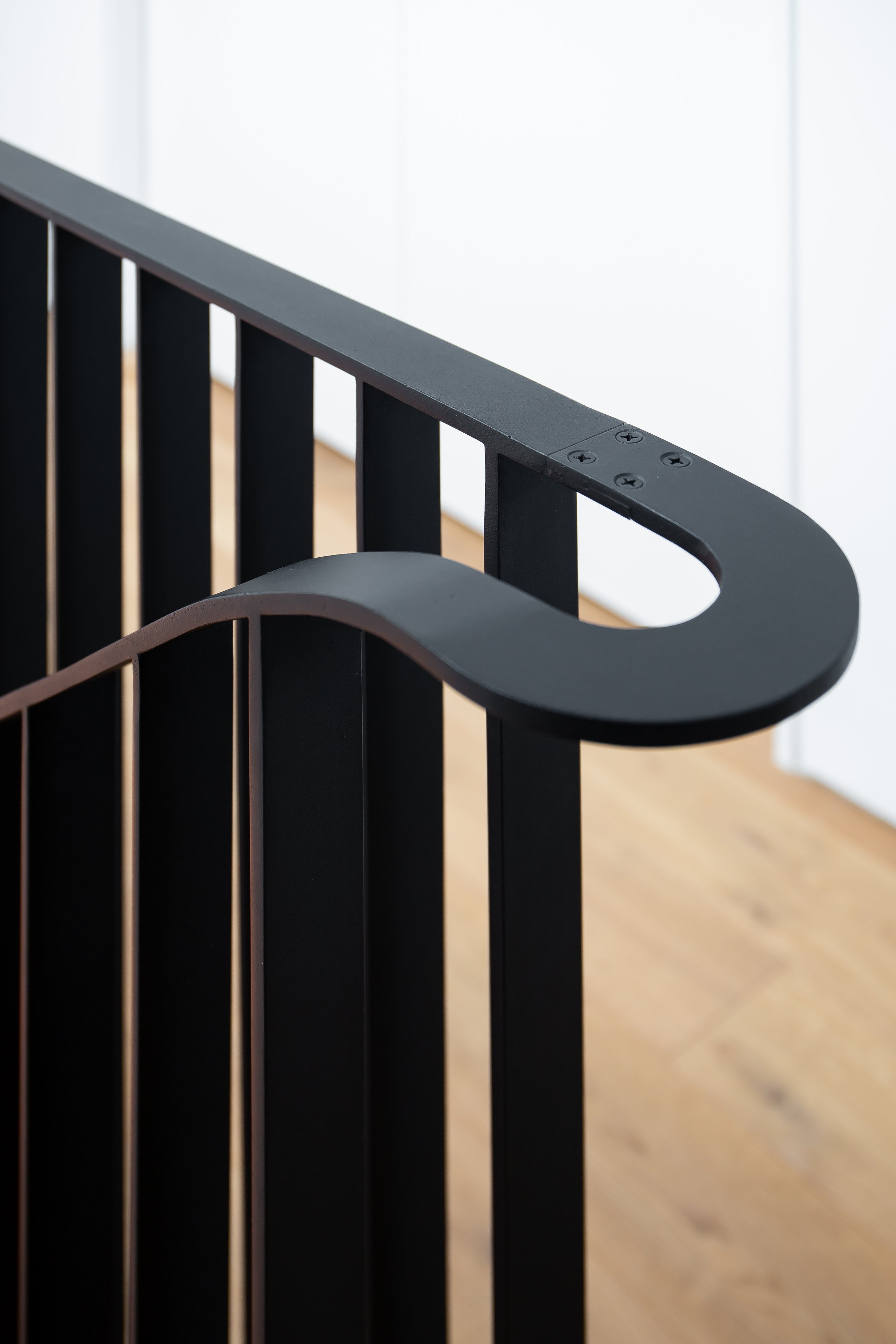 Custom curved steel staircase guardrails minimalist interior design element