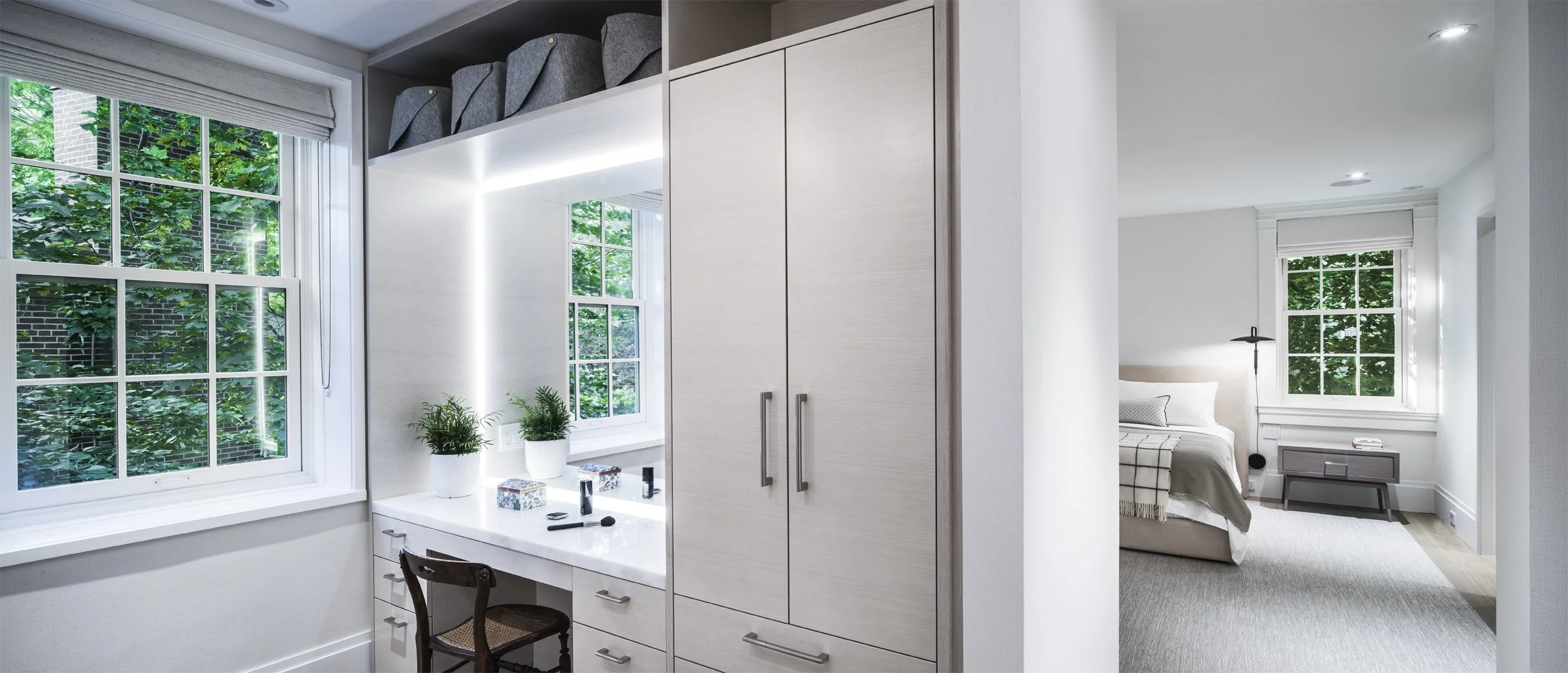 Custom white oak closet millwork and smart integrated dressing room storage layout by Toronto residential designers.