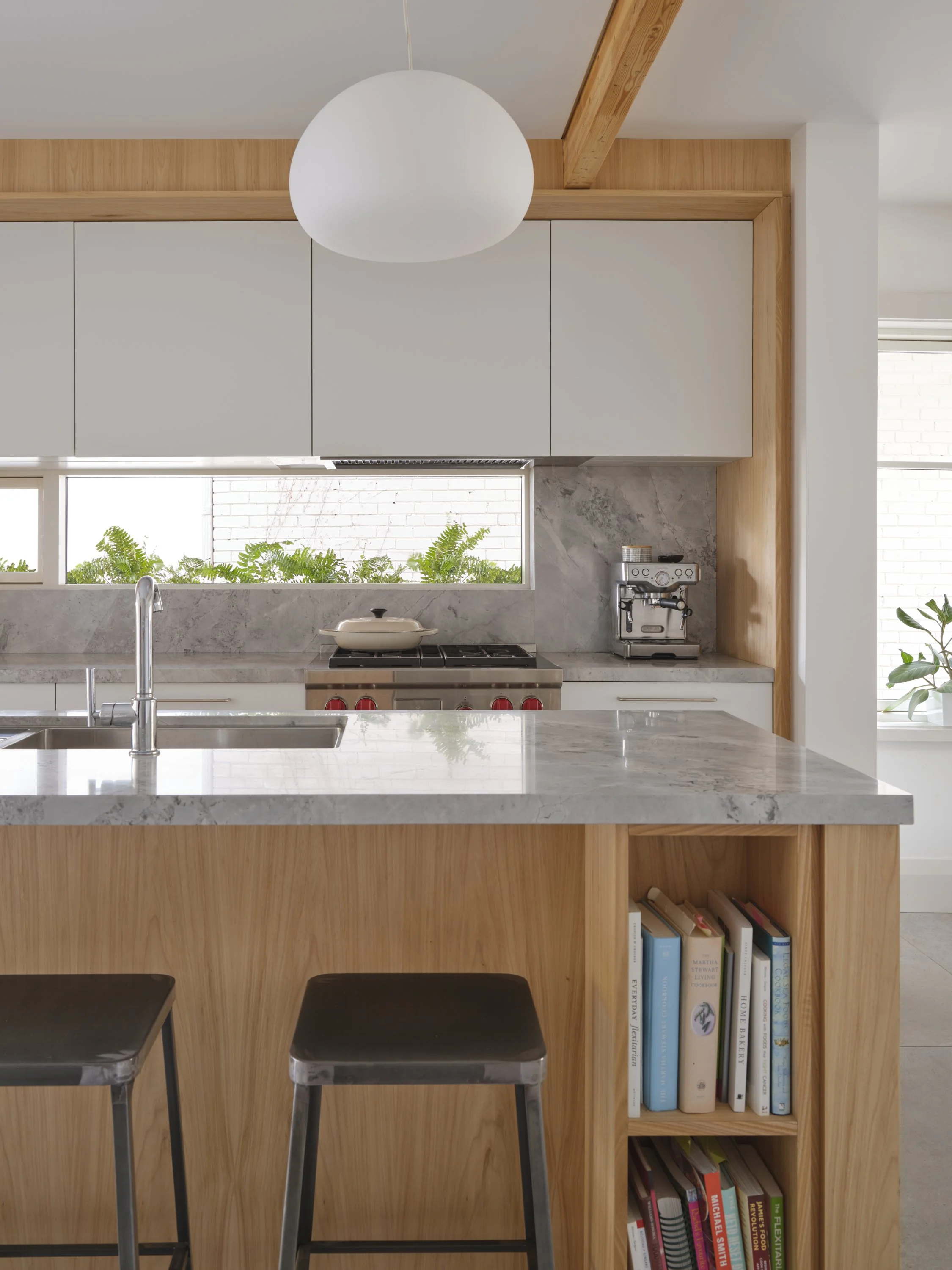 Custom grey elm kitchen millwork with natural stone countertops and integrated backsplash window herb flowerbox.
