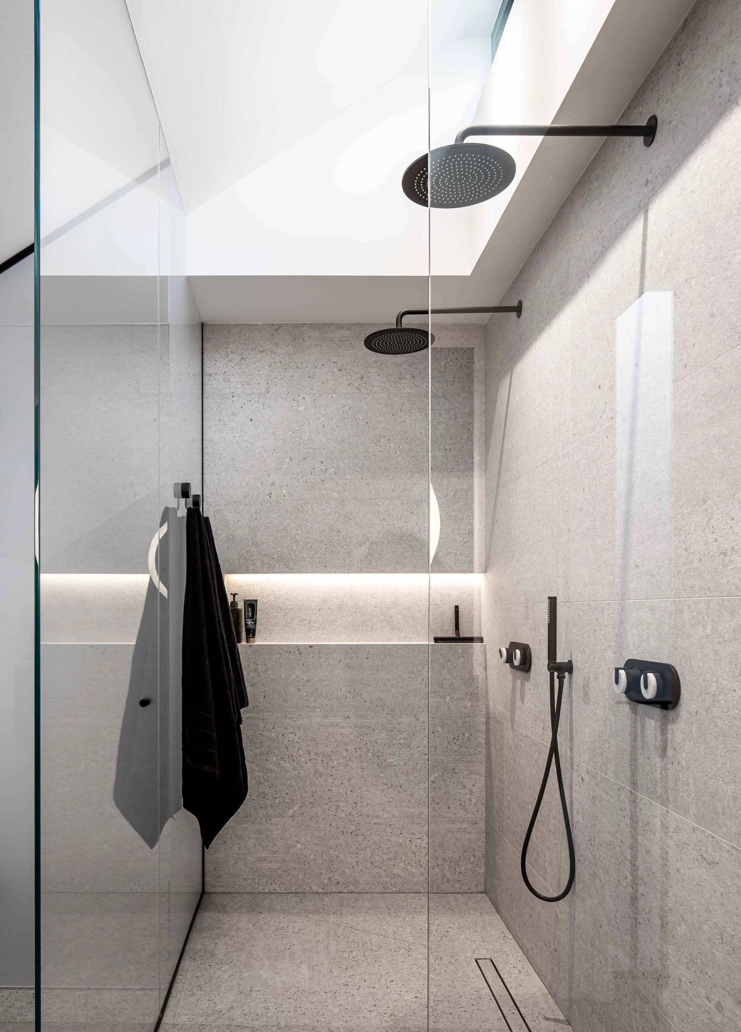 Walk-in double shower with architectural clerestory window and built-in niche