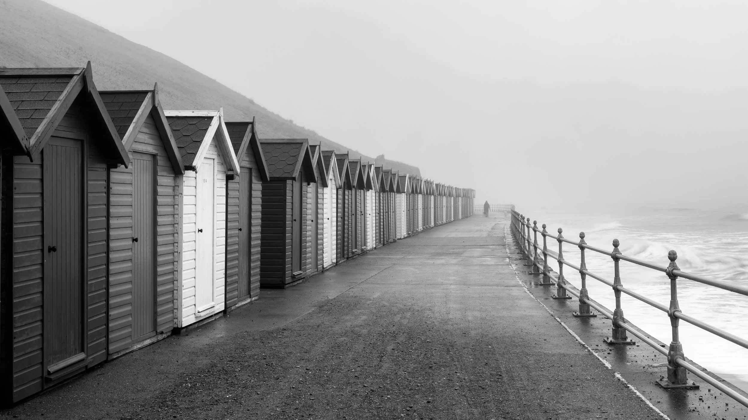 beach huts in the mist