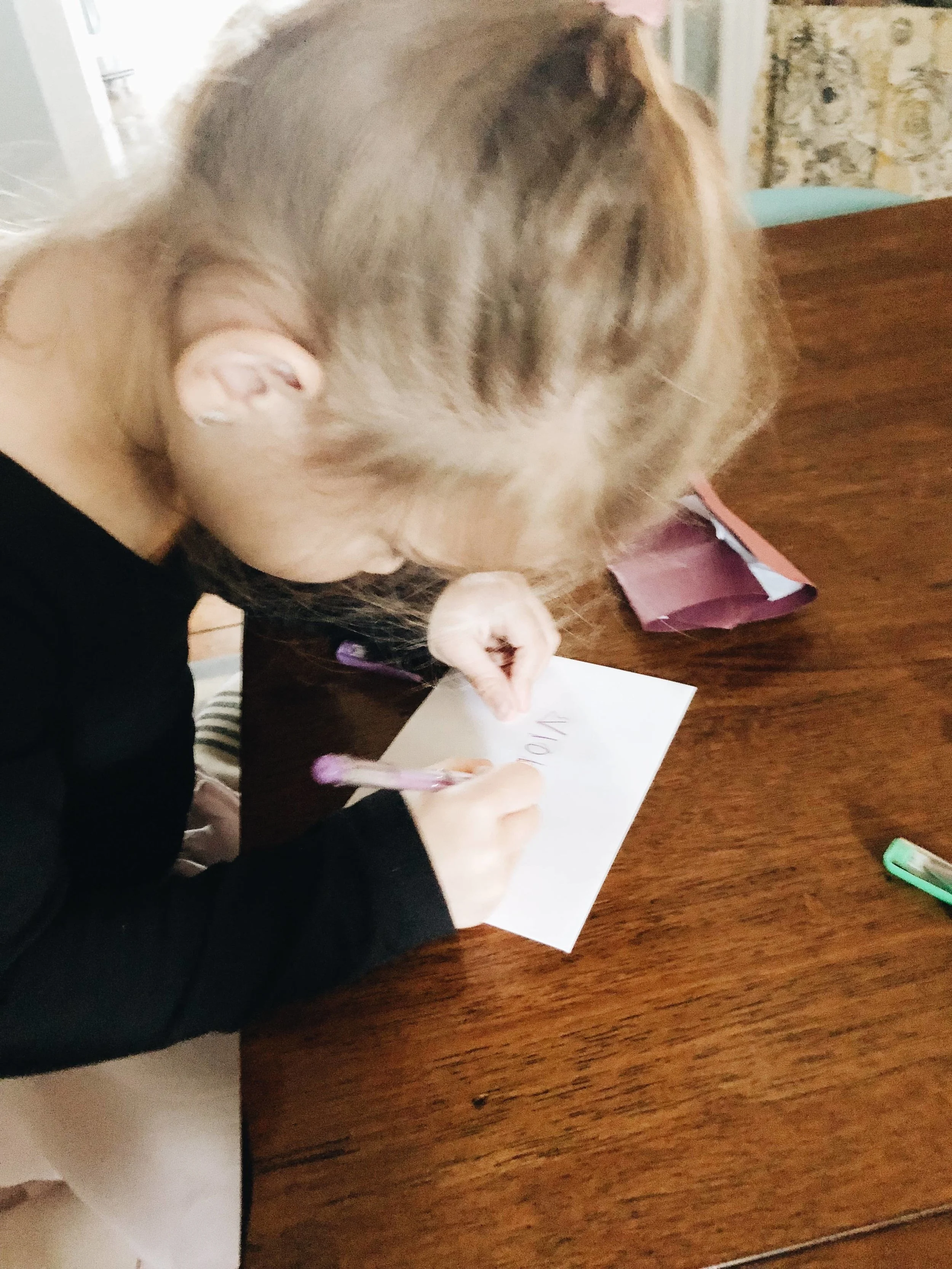 Here she is tracing the name of her friend Violet.