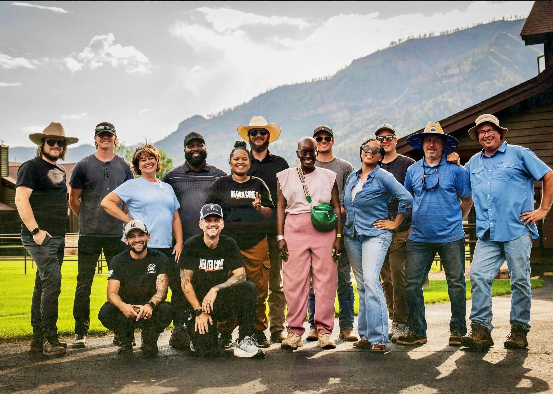 The production team poses outside a building after an equipment video shoot.