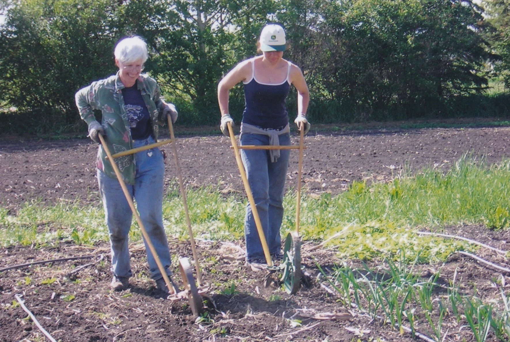 James's mom, Ruth(left), behind a wheel hoe.