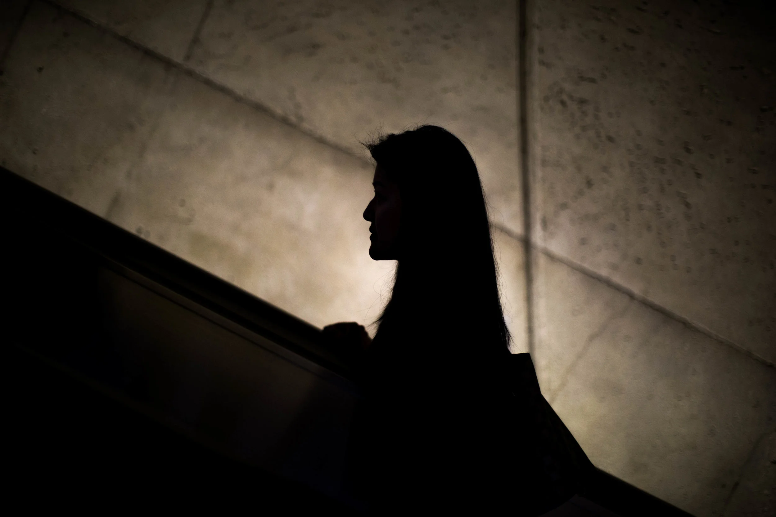 An anonymous women climbs Dupont Circle escalator on March 7th, 2018.