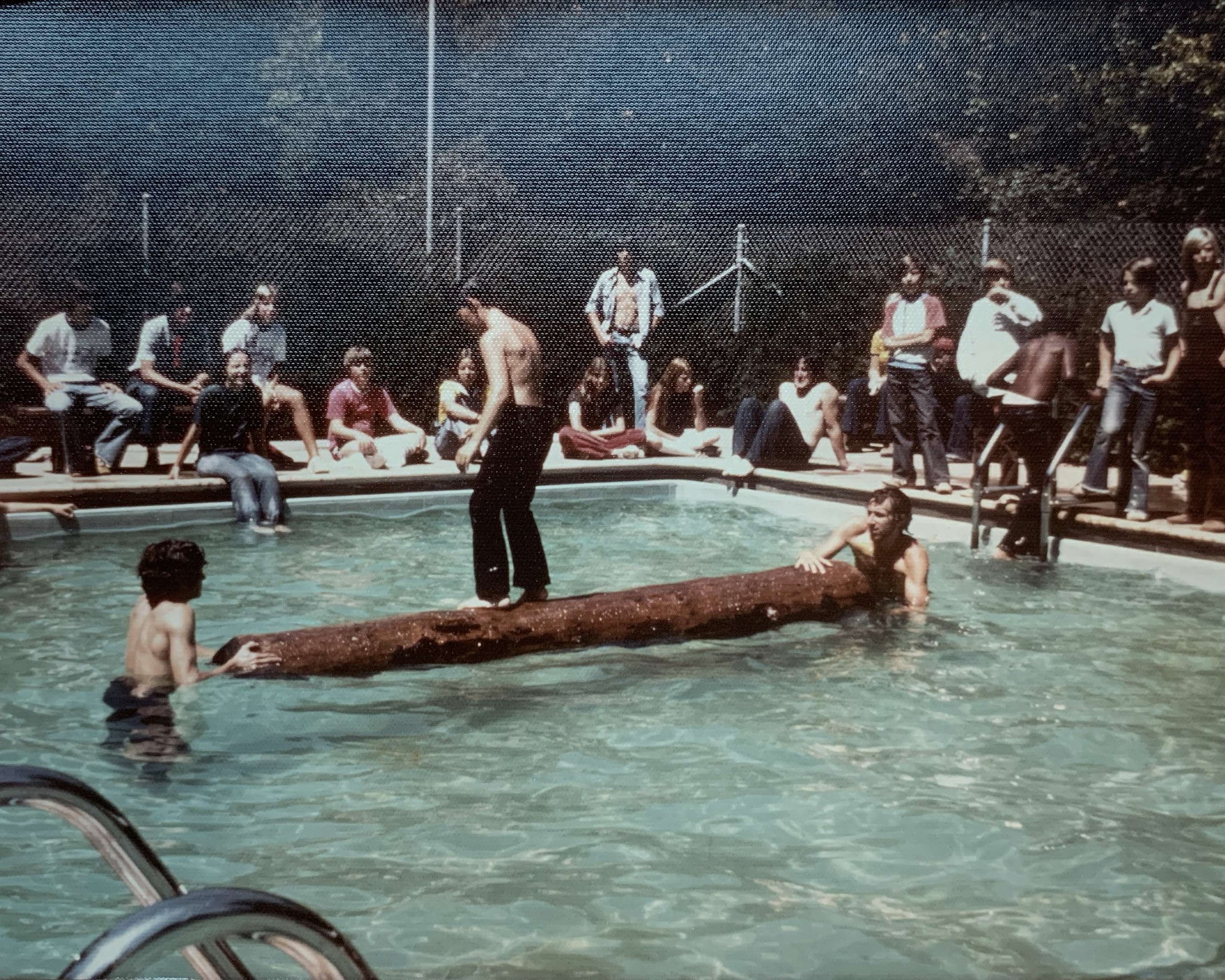 Campers in Railroad Camp participating in a log rolling competition in 1977