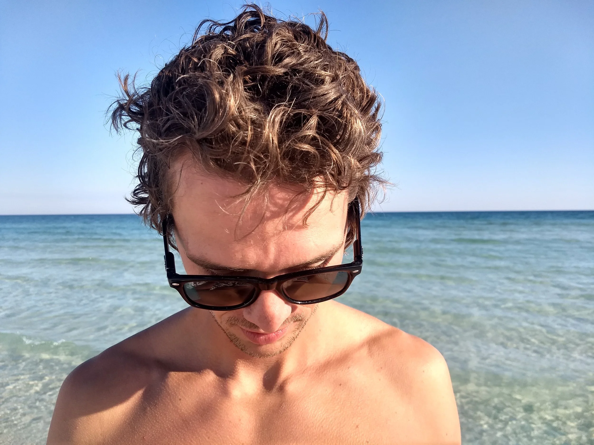 The warm waters off Florida's Gulf coast are as inviting as they look. Braden examines the unusual squeak emitted from the sand, a phenomenon caused by the spherical shape of every tiny grain of quartz rubbing against one another underfoot.