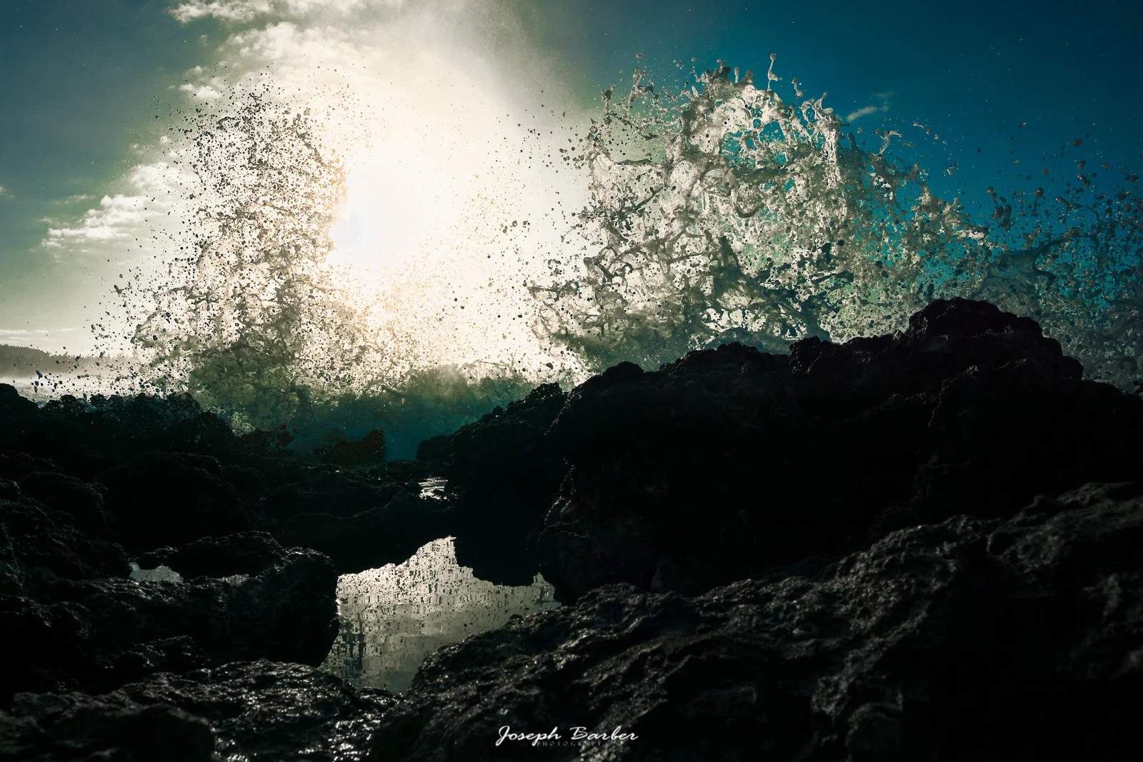 crashing wave against rocks in oahu hawaii at turtle bay resort