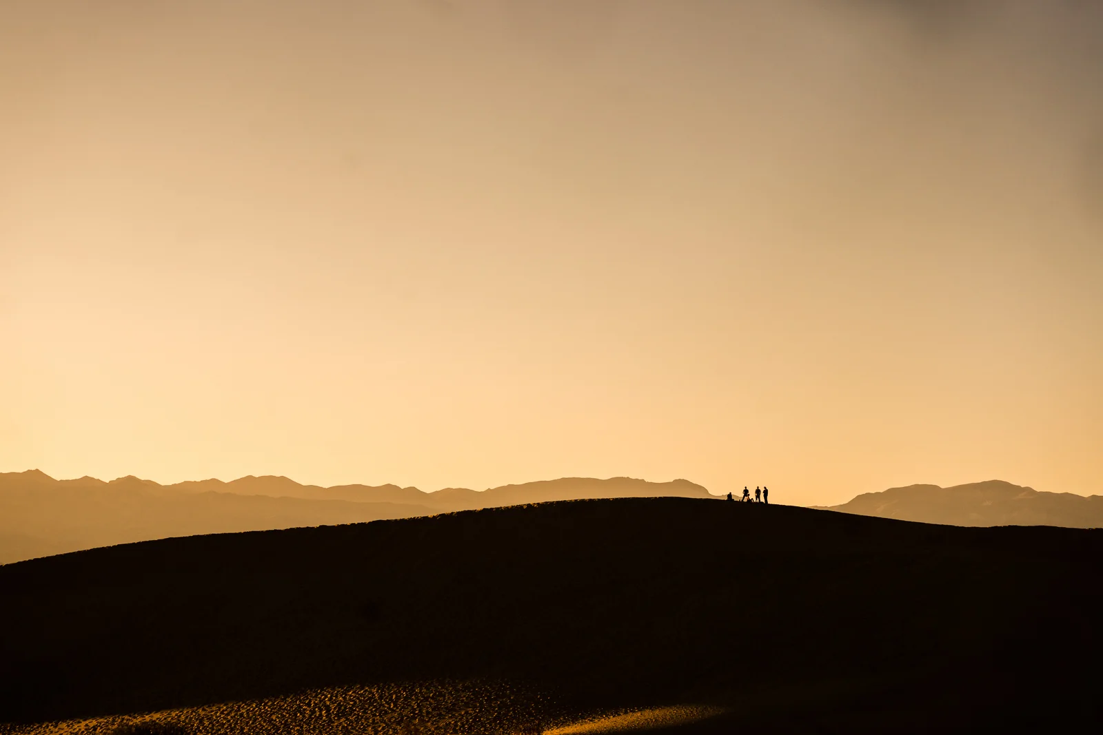 Telephoto Photograph of the death Valley Mesquite Flats sand dunes during Golden hour With a minimal And high contrast composition