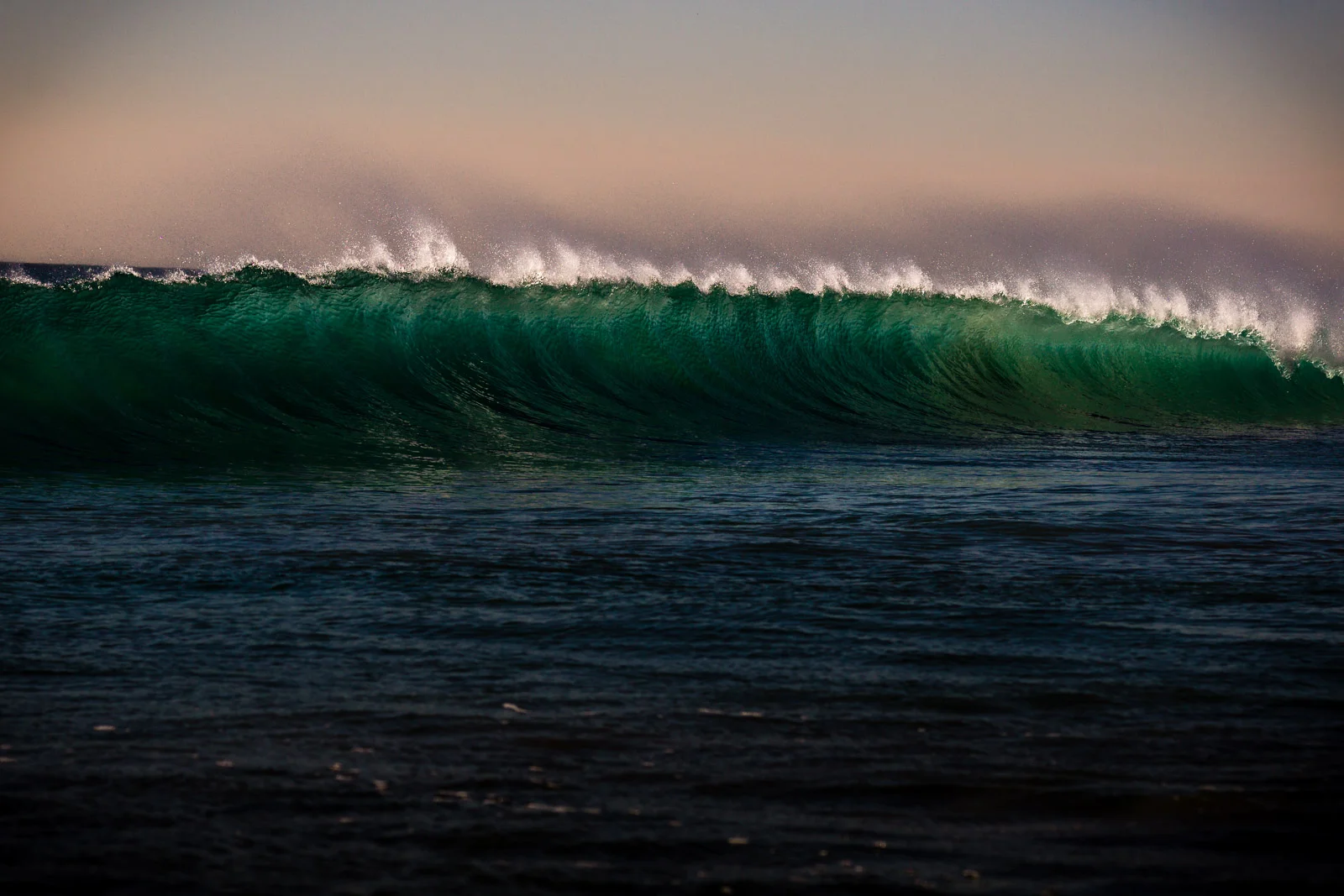 Green California wave breaking with Santa Ana offshore winds during a beautiful December afternoon in Newport Beach California Taken with the Sony alpha camera