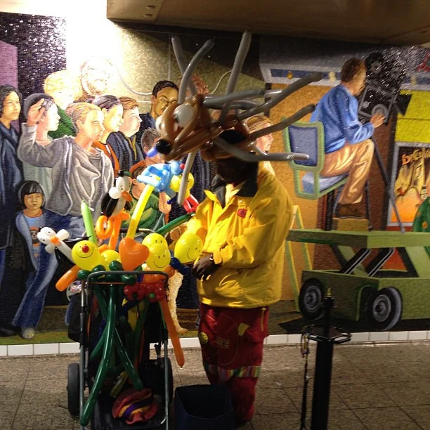 I quickly took this photo in the Times Square subway stop about a week ago. I was mainly trying to capture the delightfully absurd picture of a man wearing balloon animals, but serendipitously, he was standing in front of this Beaux-Arts mural (according to my Dad) in the station. Not only is it just a wonderfully chaotic splash of colors, but it is also striking that the balloon animal vendor is facing an opposite direction from all of the mural characters behind him.
