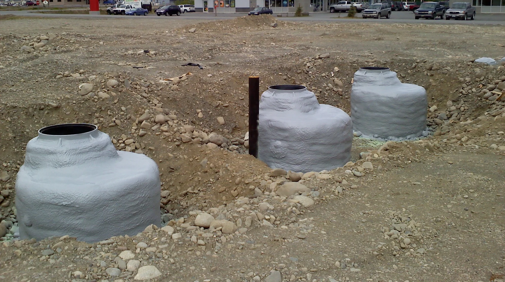 Underground storm and sewer drain risers.