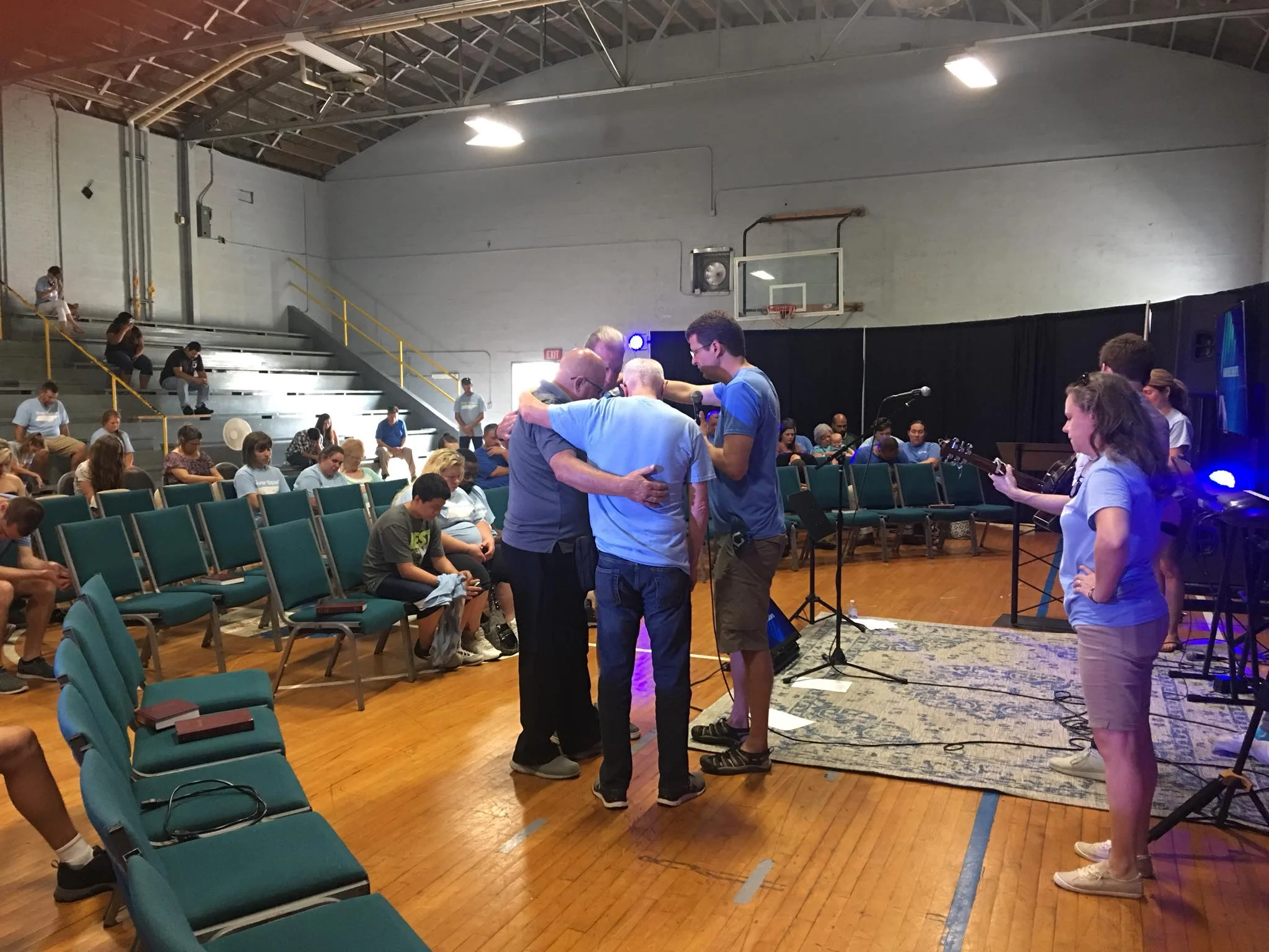 Elders praying over a mission team on a Sunday morning