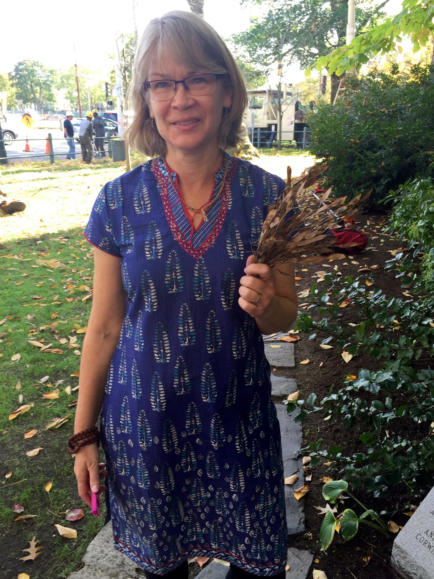 First Church minister Karen Case collected seedpods that will be shared with Arnold Arboretum and Mt. Auburn Cemetery. (Edgar B. Herwick III WGBH News)