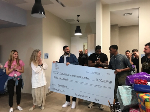 Drake presenting to the check to the Lotus House Women's Shelter, photo via TMZ