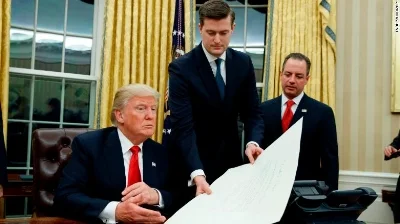 Rob Porter (center) and Trump, photo via CNN