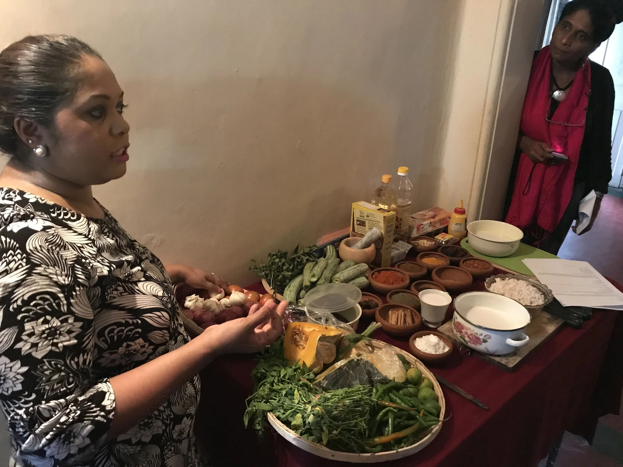 The beginning: Duneeshya explains some of the ingredients we’ll be using to prepare our traditional Sri Lankan feast (as US-SLFC Executive Director Sandarshi looks on).