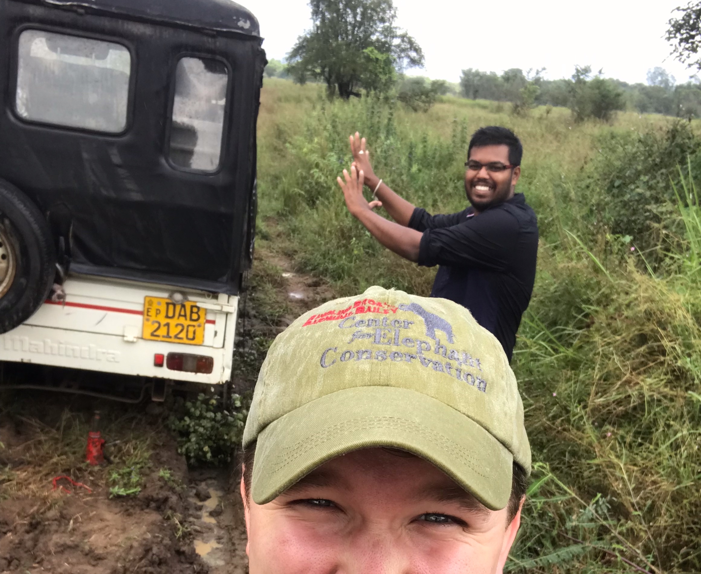 Waiting for our rescue vehicle to come. Not sure if Sachintha thinks he’s using some sort of force field to will the car out of the mud hole.