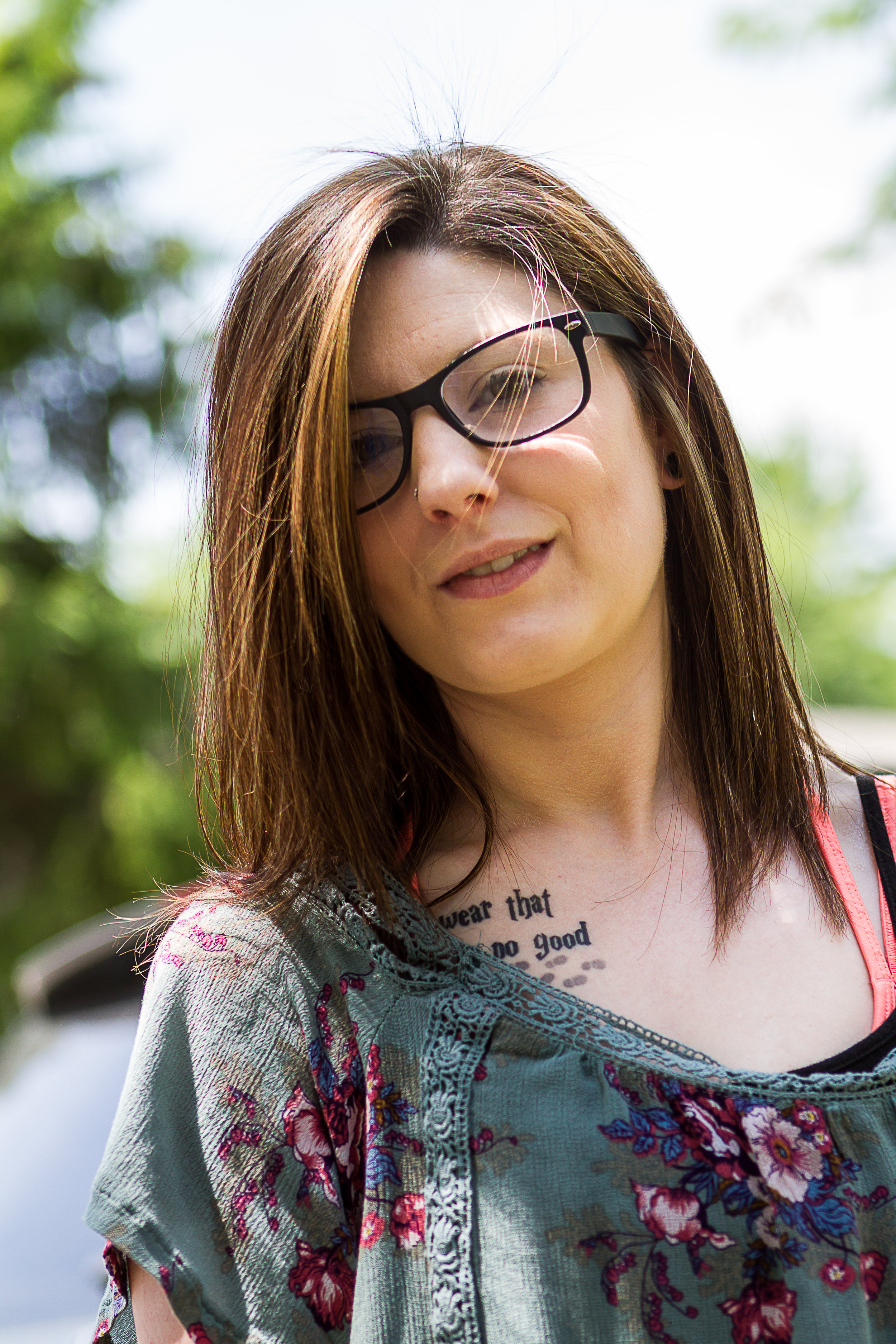 A protrait of a beautiful young woman outdoors in a neighboorhoo