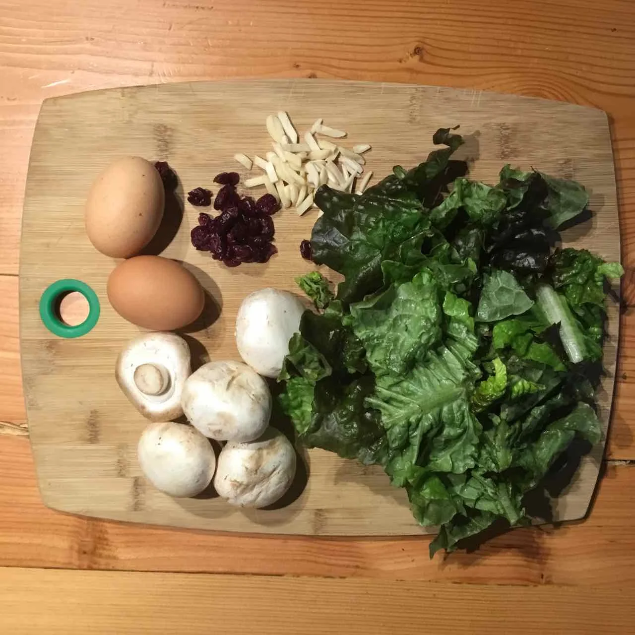 Green salad, cooked mushrooms and eggs, sliced almonds and dry cranberries.
