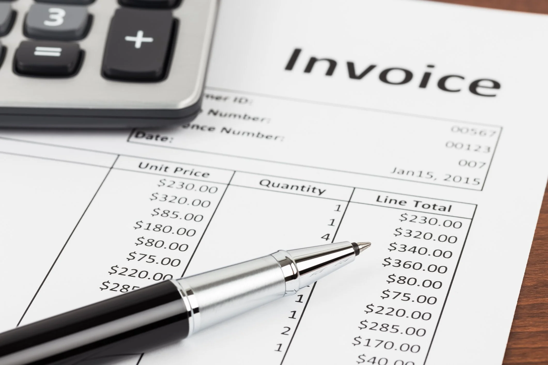 invoice, calculator and pen