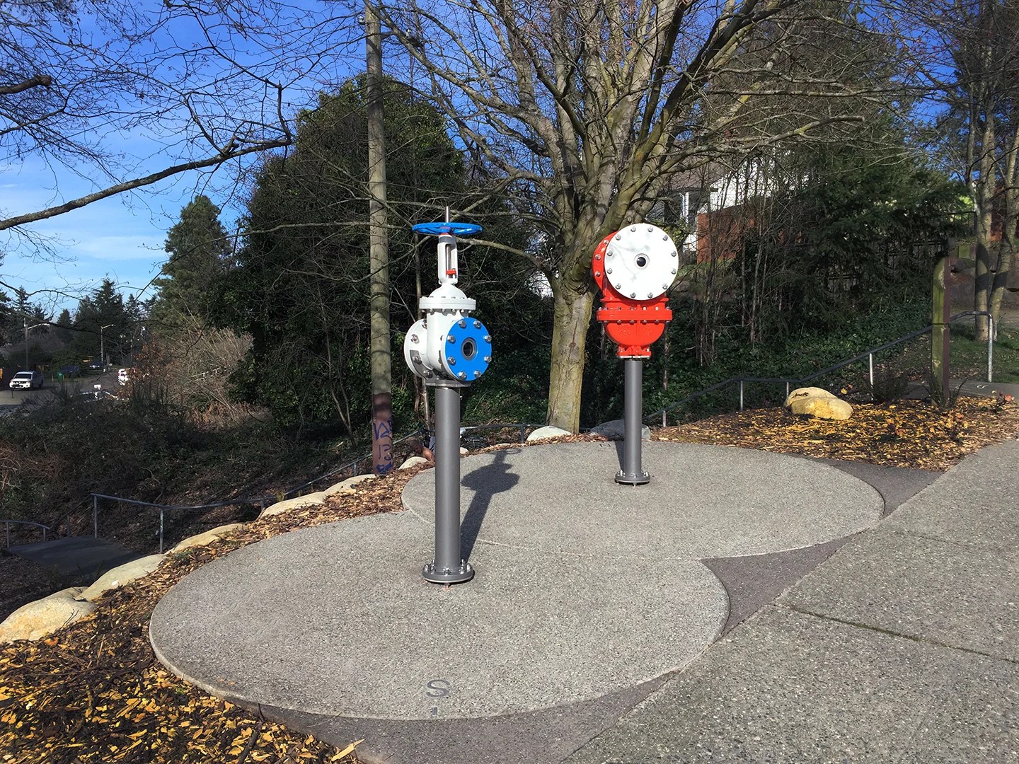 Fitting , 2016 Steel, paint, rubber, glass Delridge Combined Sewer Overlow 169, Seattle Public Utilities and the Office of Arts & Culture, Seattle, WA Two water gate valves, similar to those used by SPU, have been converted into camera obscuras. The cameras are playful, interactive devices that can be swiveled for 350˚ panoramic views to invert the view and turn the neighborhood upside down.