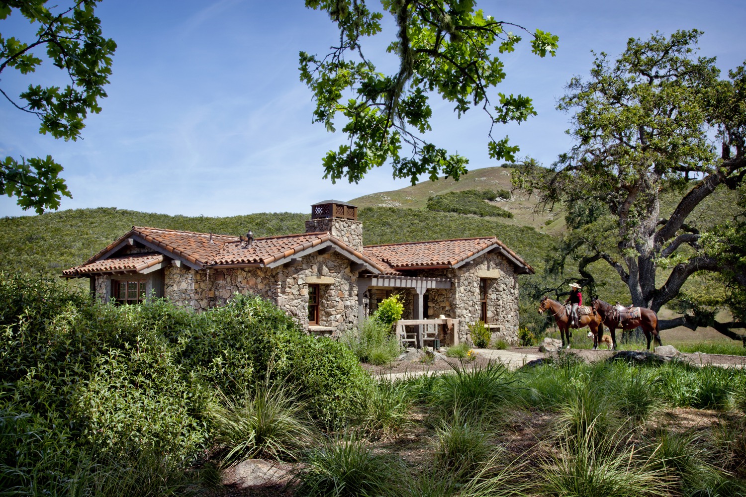 The guesthouse has a strong western theme, inside and out, with a hitching post creating the railing for the front porch.