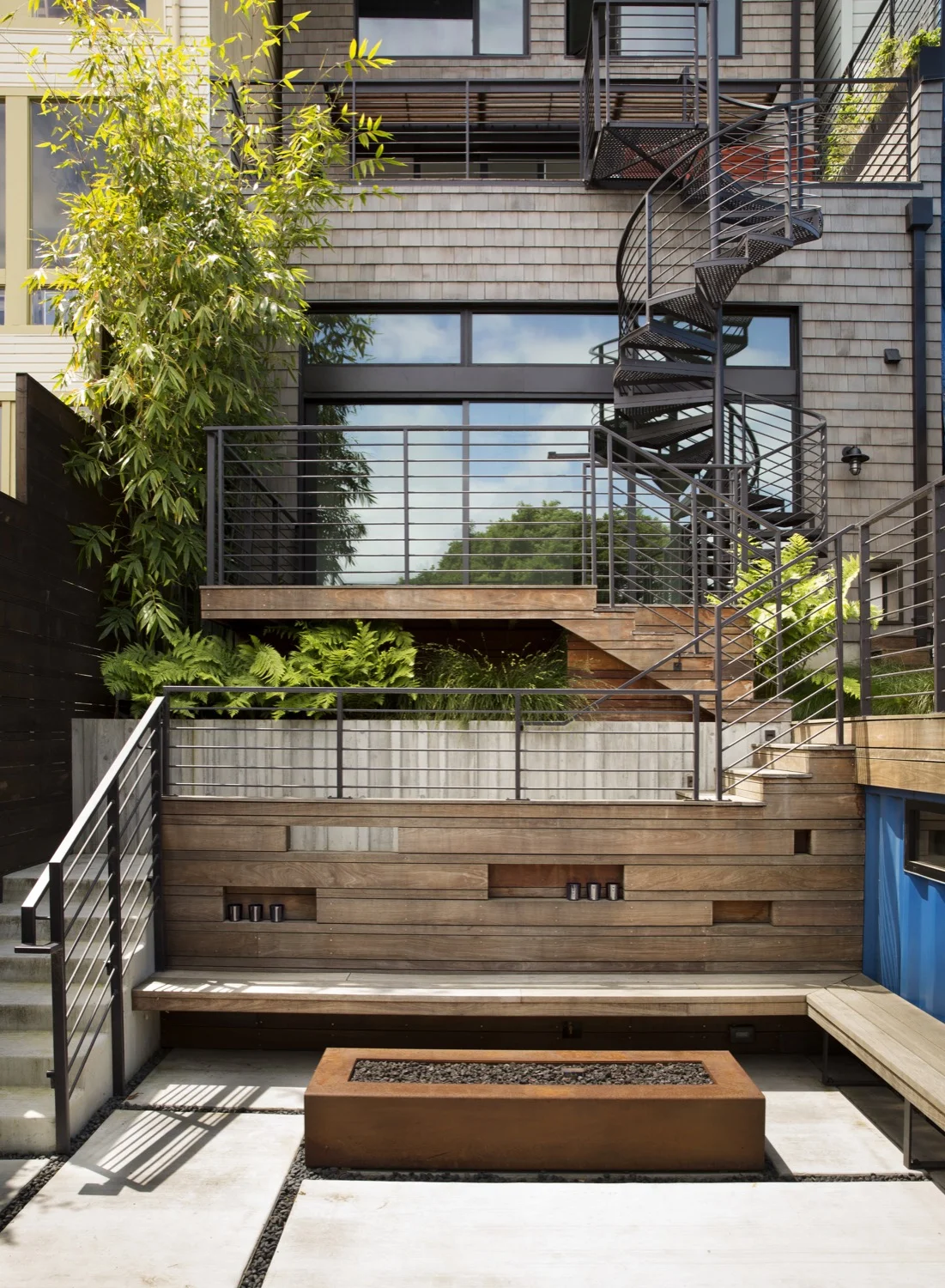 Decks connect on four levels of the building to provide an easy way for the family to access their backyard from a tall, narrow home.