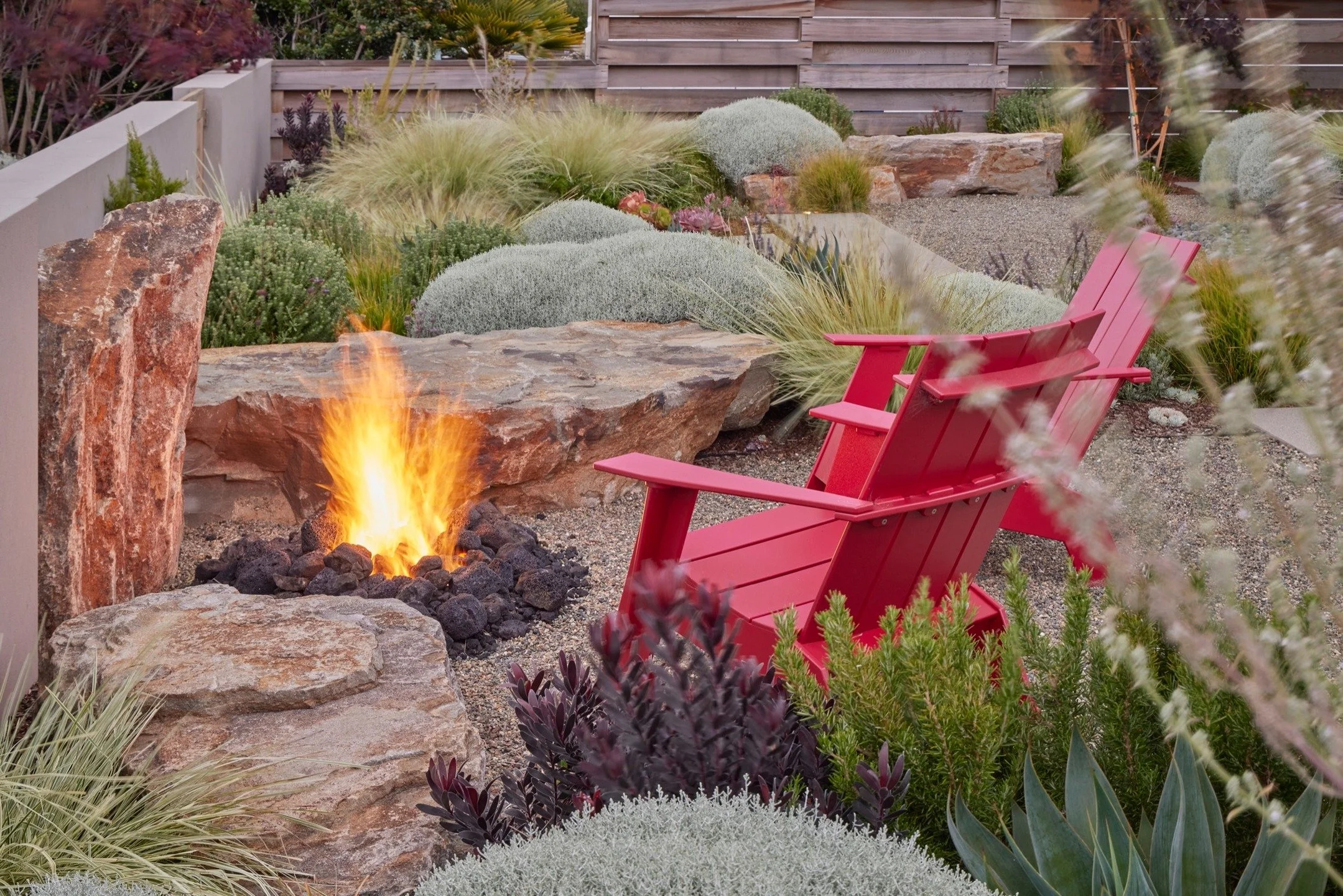 In this #arterrafridayfeature, boulders create a cozy firepit gathering area.

Architect: @studio_schicketanz
General Contractor: Miller &amp; Associates Concrete
Landscape Contractor: Landscaping by the Sea
Photographer: @caitlinatkinson_photography