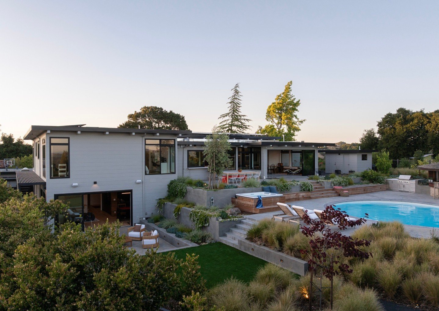 Connecting the different levels of a home in a way that is visually pleasing is the focus of this #arterrafridayfeature grading.

Terracing between the levels not only eliminated guardrails, it kept the kids zone just close enough to the adults.

Arc