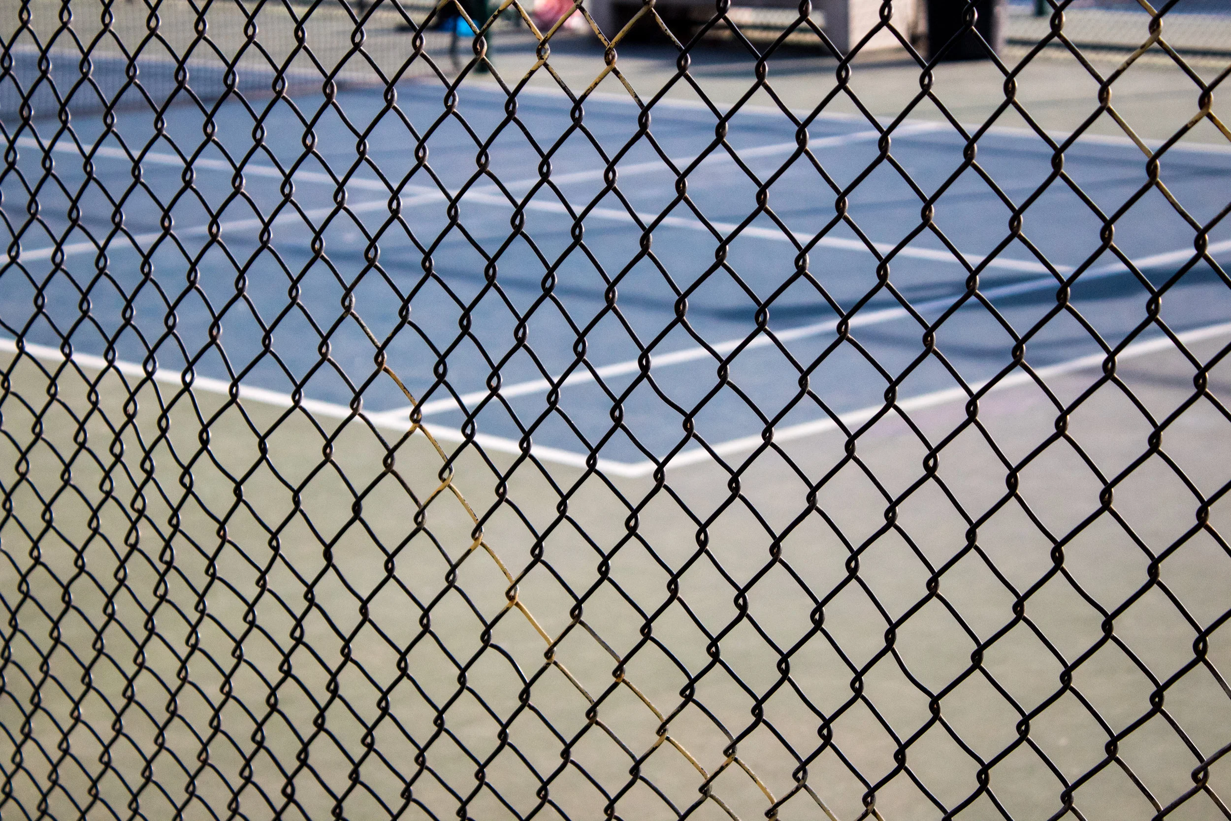 TennisCourtThroughFence.jpg