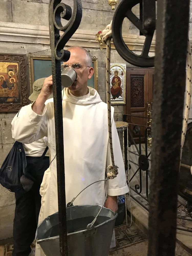 Drinking at Jacob's Well (see John chapter 4). The masonry dates back to before Our Lord's time!