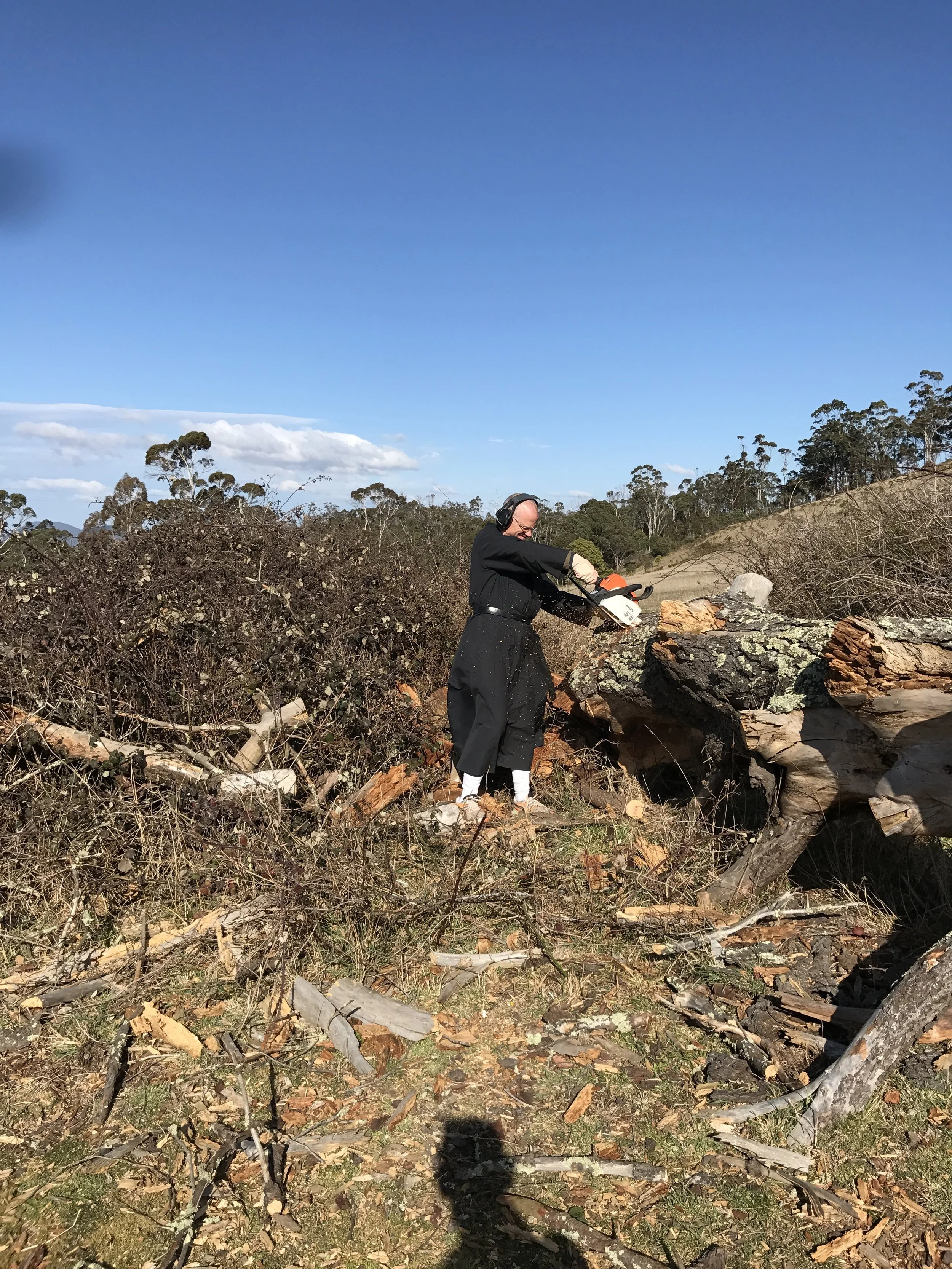 Father Prior having a great time with the chainsaw...